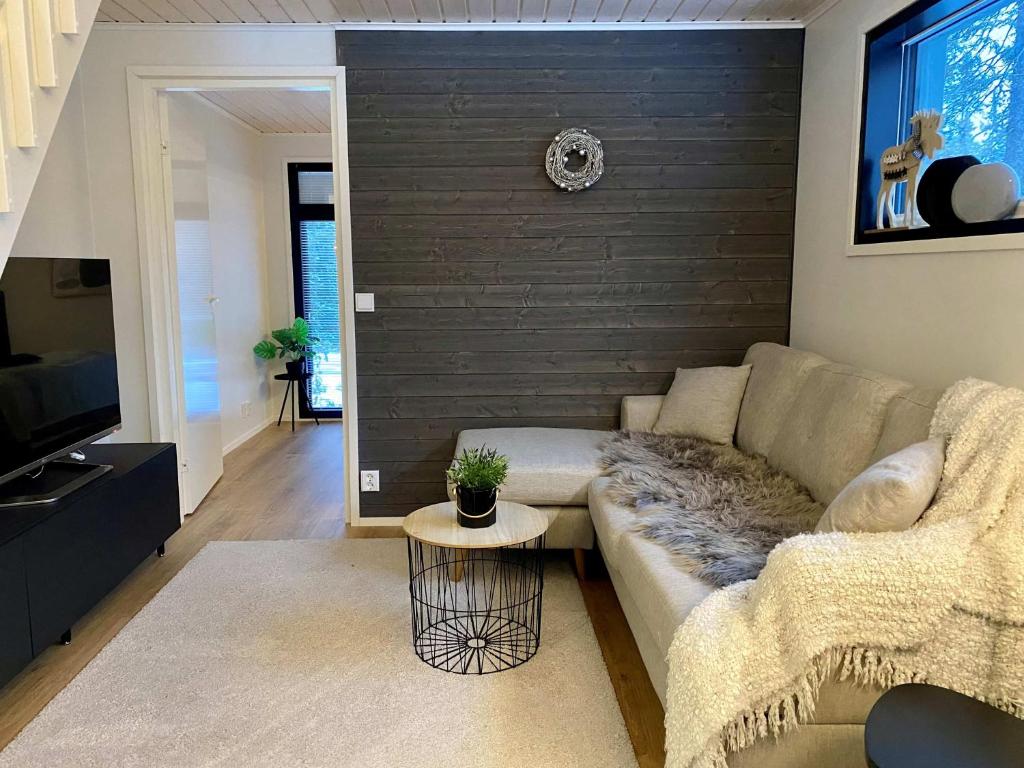 a living room with a couch and a table at Villa Anilia in Syöte