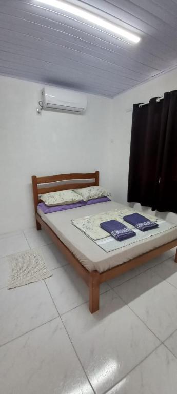 a bedroom with a bed in a room at Pousada Germânia em Paraíso do Sul RS in Paraíso do Sul