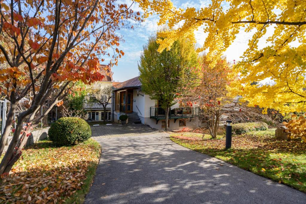 a house in the fall with a driveway at Pension Christina in Weiz