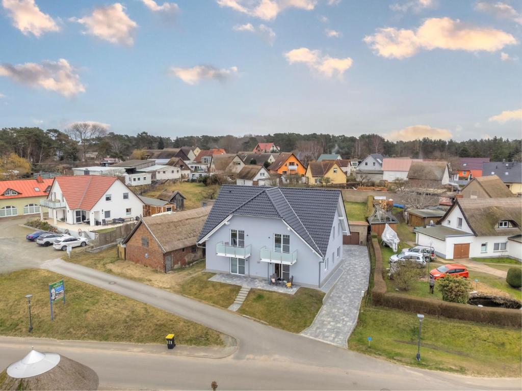 an aerial view of a small town with houses at Haus Achterwasserblick 1 in Loddin