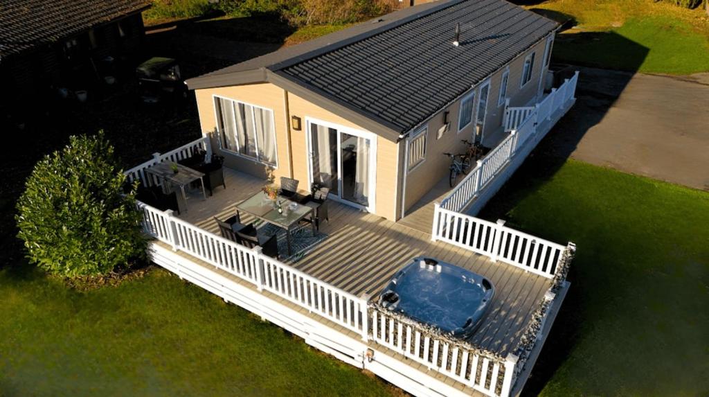 an aerial view of a house with a deck and a car at Goaty Lodge - 2 The Green in Tattershall