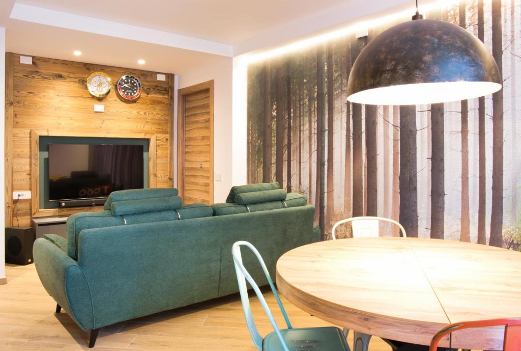 a living room with a couch and a table at El Surcinel – Alpine Design Home in Ballabio
