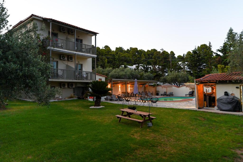 a building with a picnic table in a yard at Aggelos Grand in Koukounaries