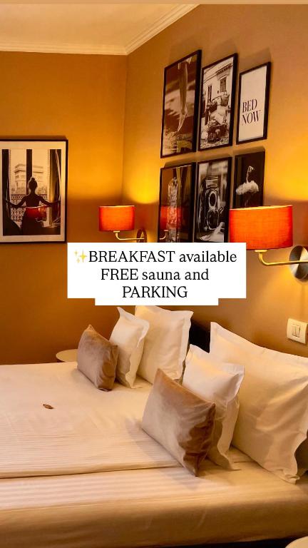 a bedroom with a bed with pictures on the wall at Pensiunea Marylou in Alba Iulia