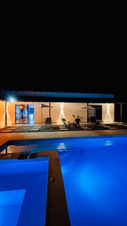 a swimming pool at night with blue lights at Villa Serena Sopetran in Sopetrán