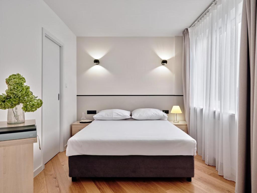 a bedroom with a large bed with white sheets at Apartamenty Media Park in Warsaw