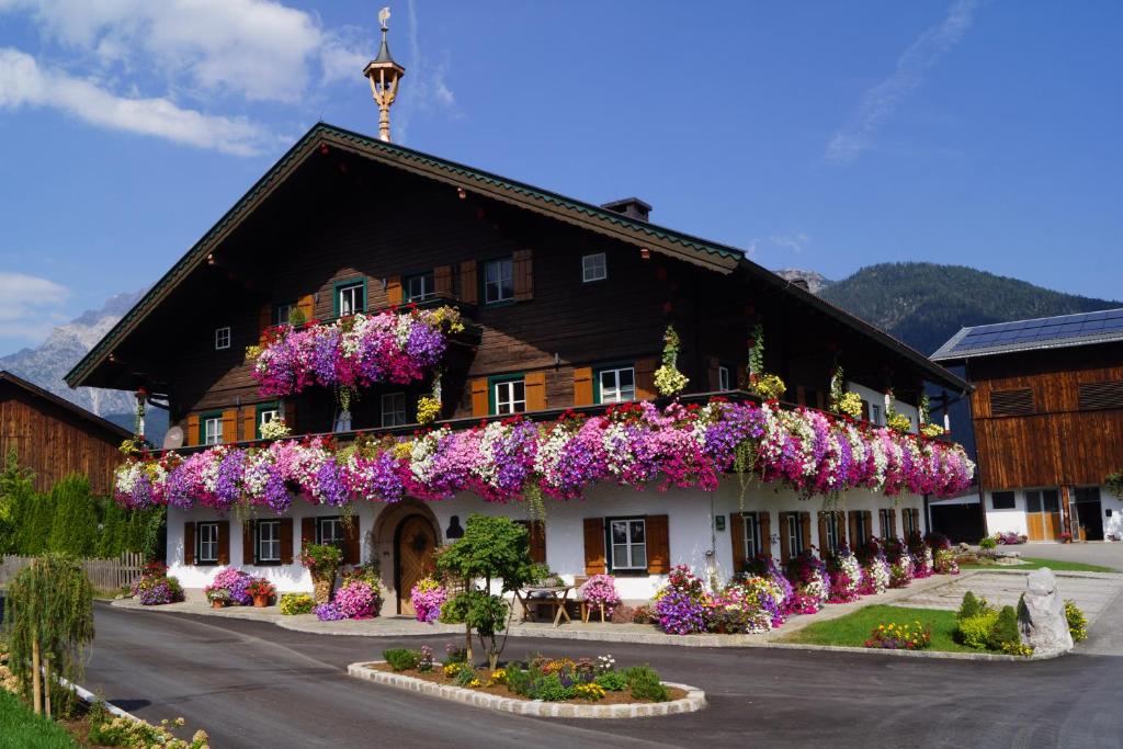 a building with flowers on the side of it at Thomanhof Chalet-Appartement in Saalfelden am Steinernen Meer