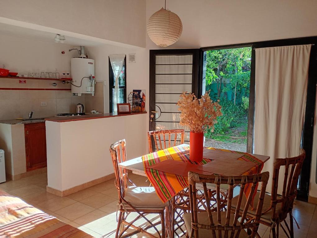 a kitchen and dining room with a table and chairs at Arcadia in Merlo