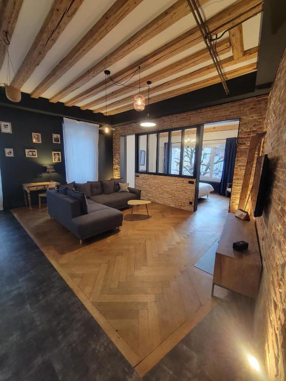a large living room with a couch and a table at Le Loft Des Arts in Thonon-les-Bains