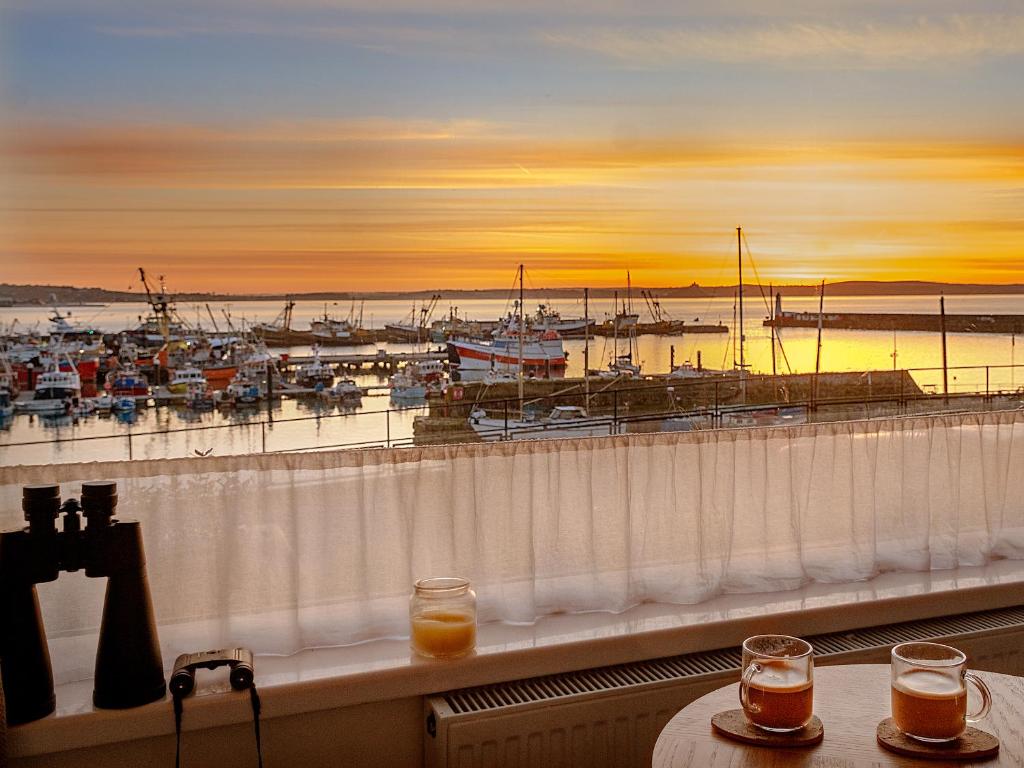 a balcony with a view of a marina at Old Quay in Newlyn