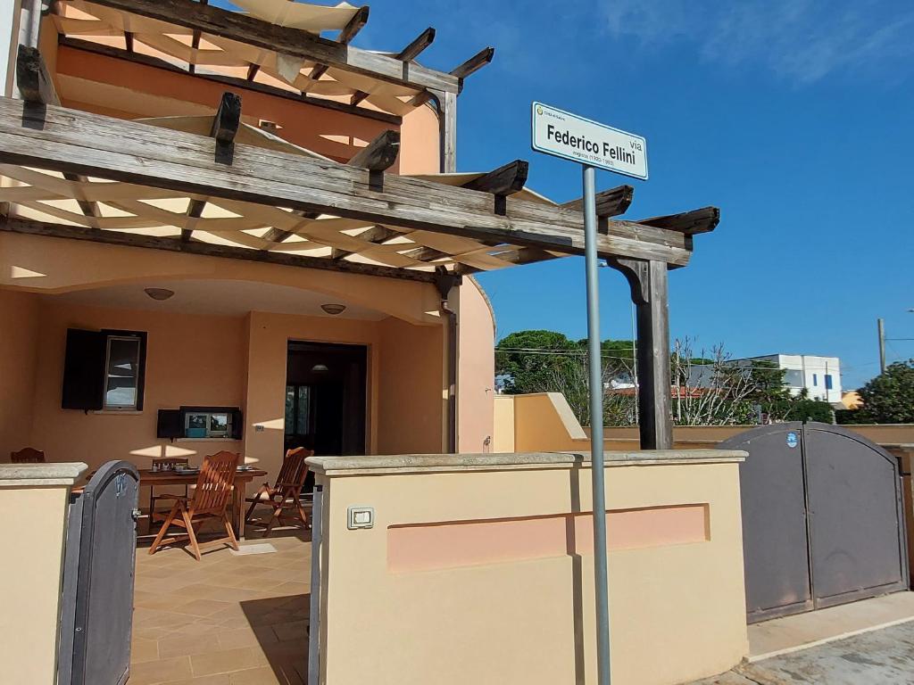 a pergola with a sign on a patio at 023 e 024 Tulipano di SalentoInVacanzaCOM in Torre Pali
