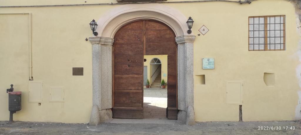 an entrance to a building with a large wooden door at Quadrifoglio Center in Ameno
