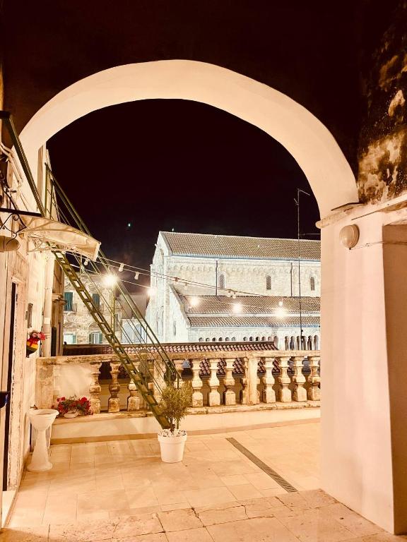 an archway with a building in the background at night at Casa Apuliae Bed & breakfast - Cathedral view in Bitonto