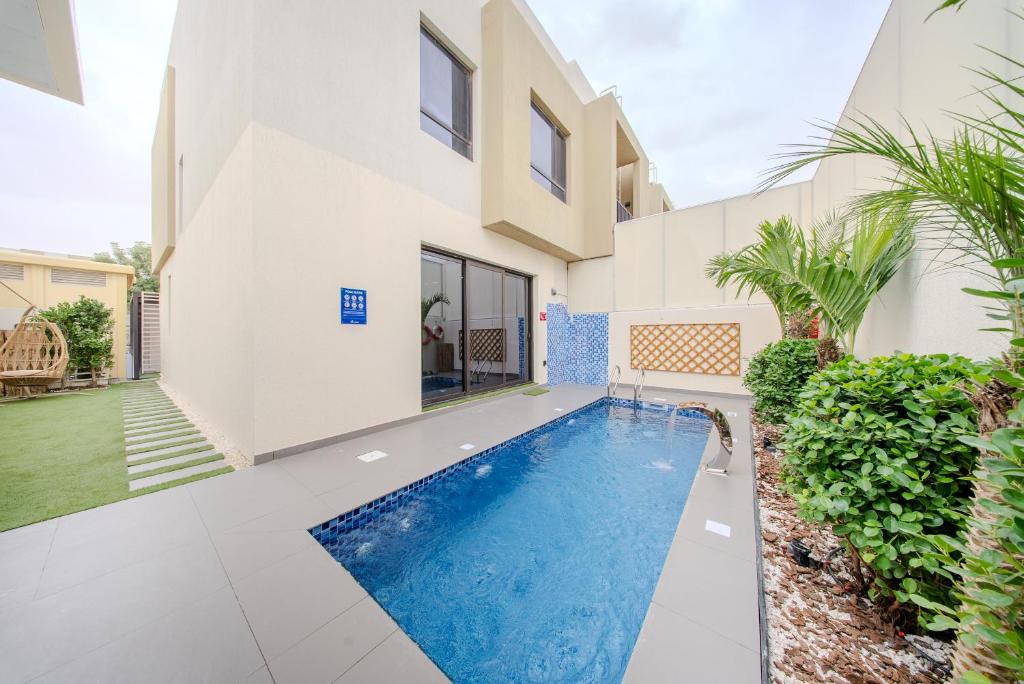 a swimming pool in the backyard of a house at 3BR Amazing Villa - Private Pool - 3WC - BBQ Pit in Sharjah