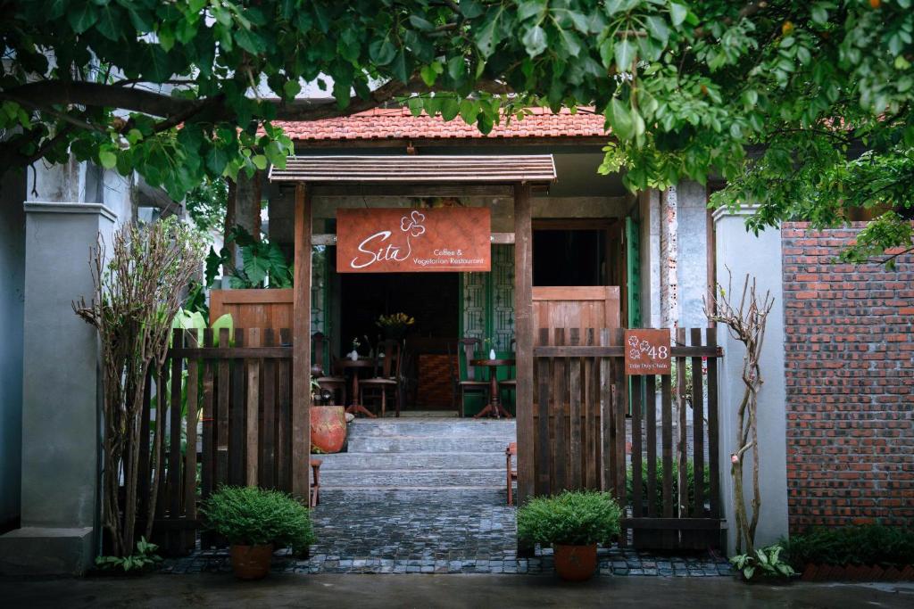 an entrance to a building with a gate and a restaurant at Sita Home in Danang