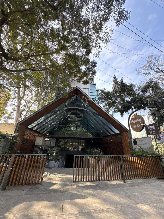 a building with a wooden fence in front of it at Zipp Hotel Rosalba in Bangalore