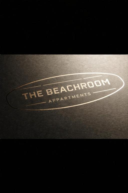 a sign that says the beechatown antiquities at Tiny House Beachroom in Scheveningen