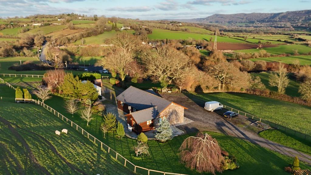 an aerial view of a farm with a barn and a fence at Whitehall Farm in Caerleon