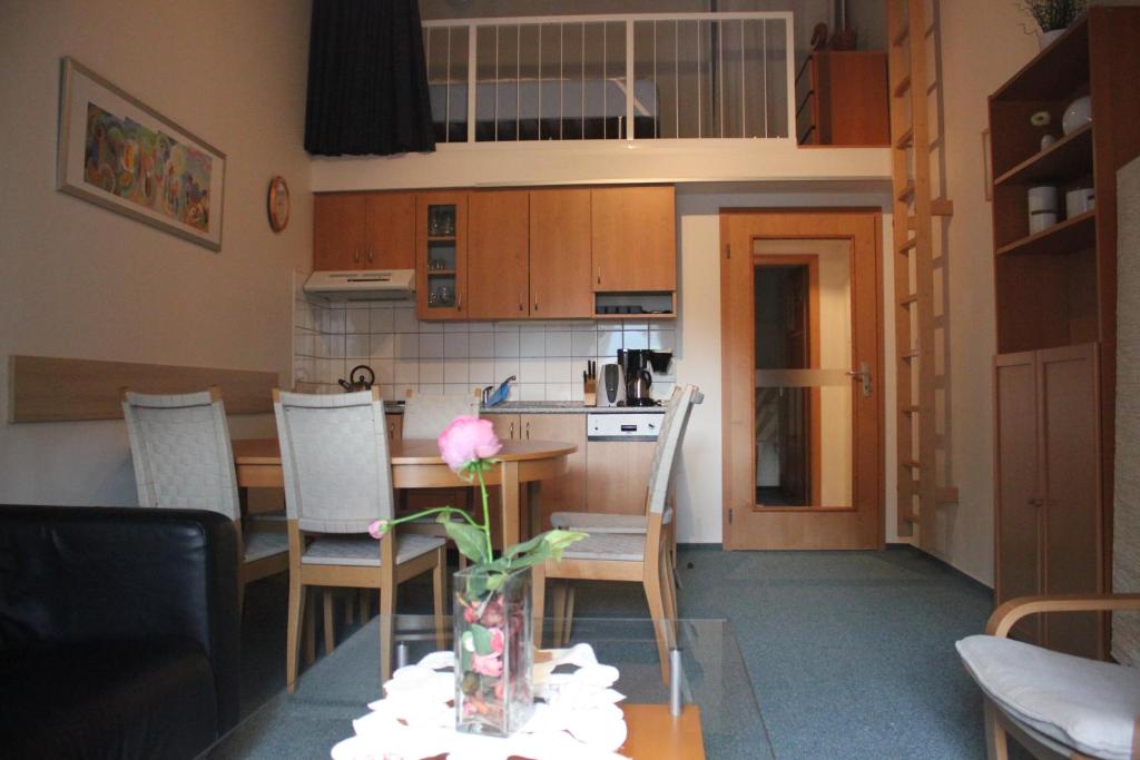 a living room and kitchen with a table and chairs at Apartment Poustevník in Pec pod Sněžkou