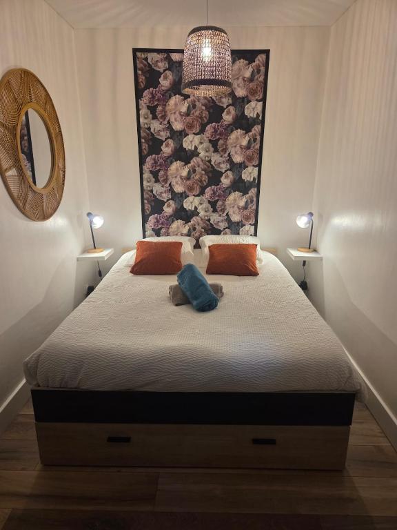 a bedroom with a bed with a floral headboard at le Thermal 108 in Saint-Martin-d'Uriage