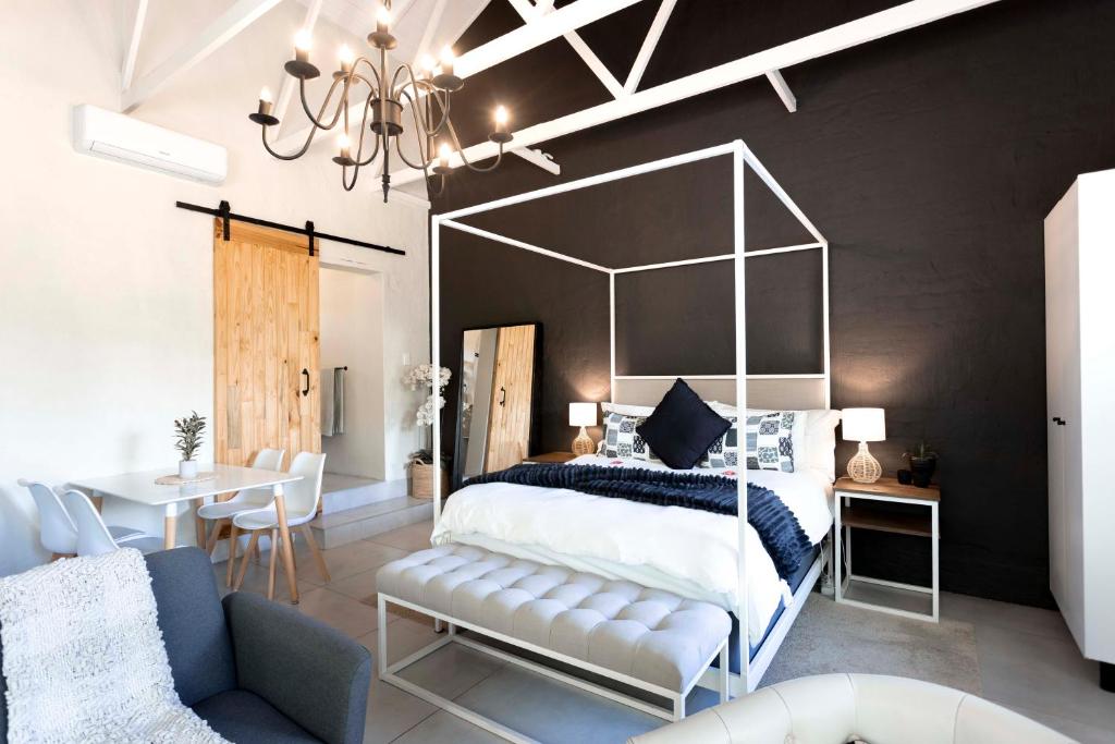 a bedroom with a large bed and a table at Hilton Cottage in Hilton