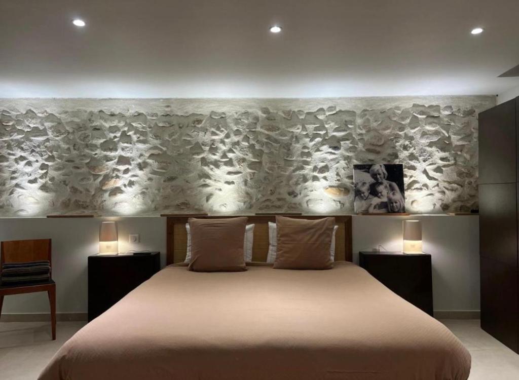 a bedroom with a large bed with two night stands at DURANCE in La Brillanne