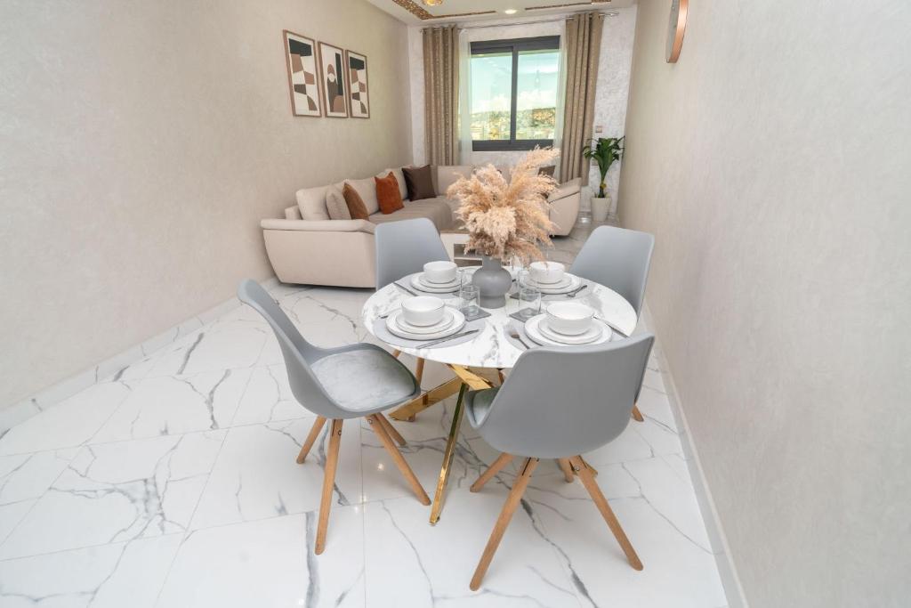 a dining room with a table and chairs at Luxury Abraj YK 120m2 in Tangier
