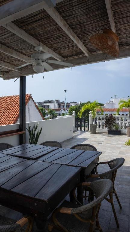 a wooden table and chairs on a patio at Art Hotel Getsemani in Cartagena de Indias