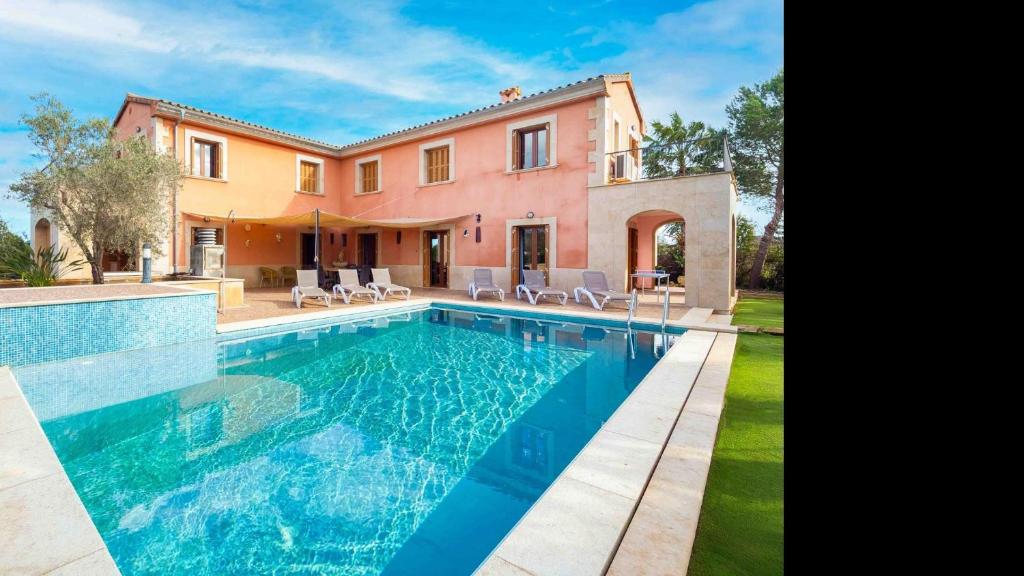 a house with a swimming pool in front of it at Son Monget in Muro
