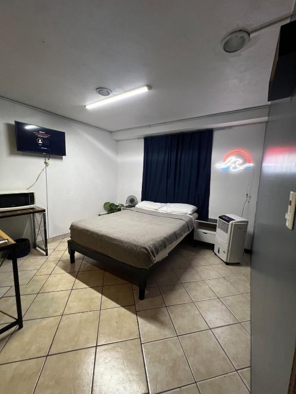 a bedroom with a bed and a television in it at Estudio in Zamora de Hidalgo