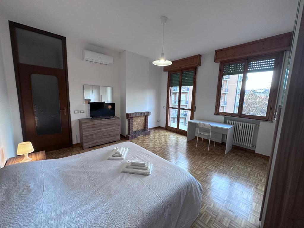 a bedroom with a large white bed with towels on it at Hospital - WI-FI 3 Bedrs in Reggio Emilia