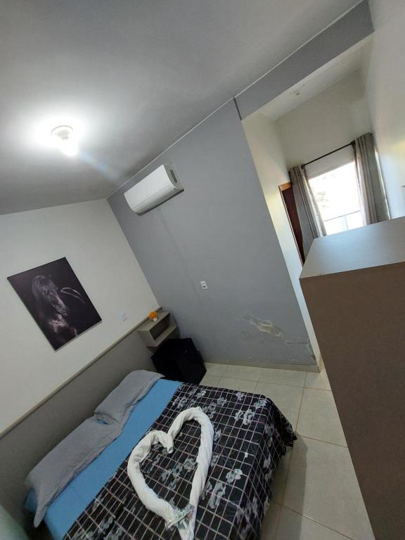 a bedroom with a bed with a heart made out at Suíte Casal - Queen's Hotel in Formosa