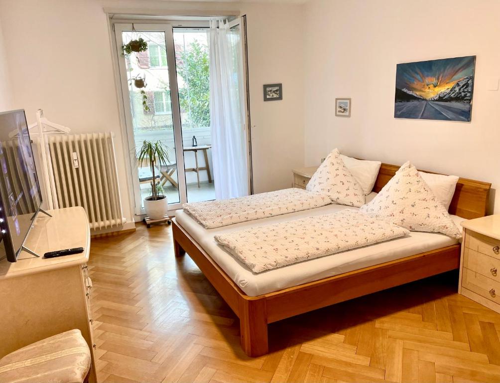 a bedroom with a bed and a television in it at Art studio 64 in Basel
