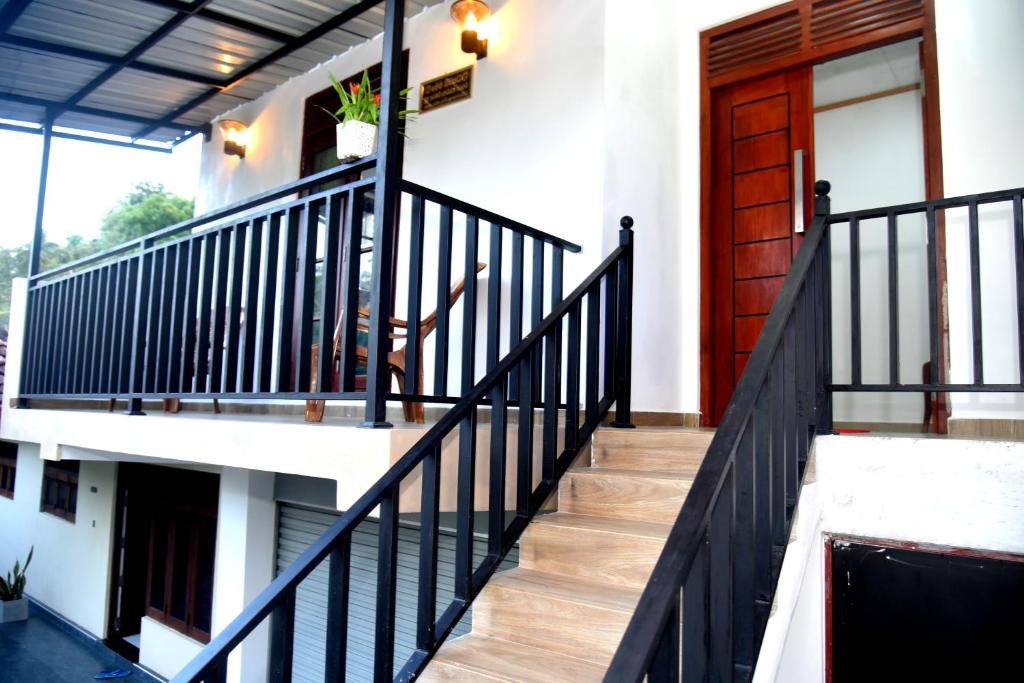 a staircase in a house with a red door at AERO View Villa in Induruwa