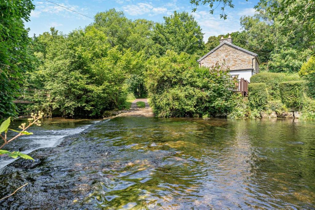 a river with a house in the middle of it at 2 Bed in Blackmill oc-c29623 in Brynmenin