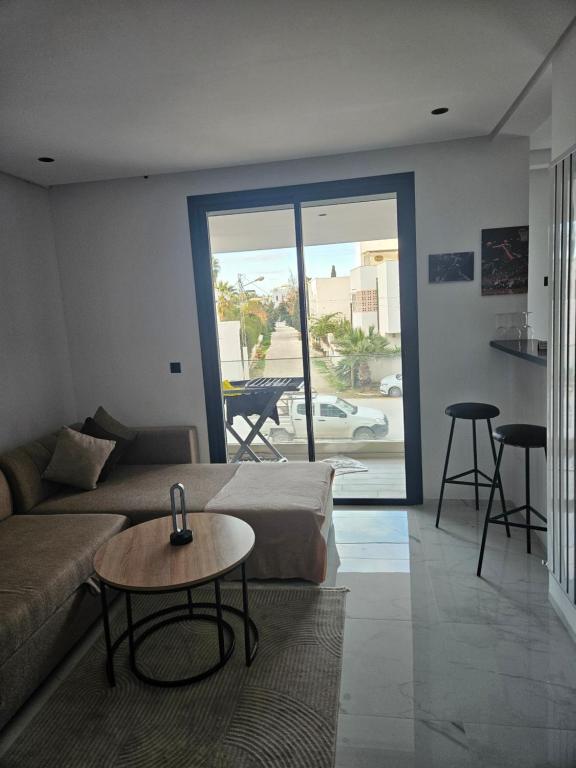 a living room with a couch and a table at loft in El Aouina Station