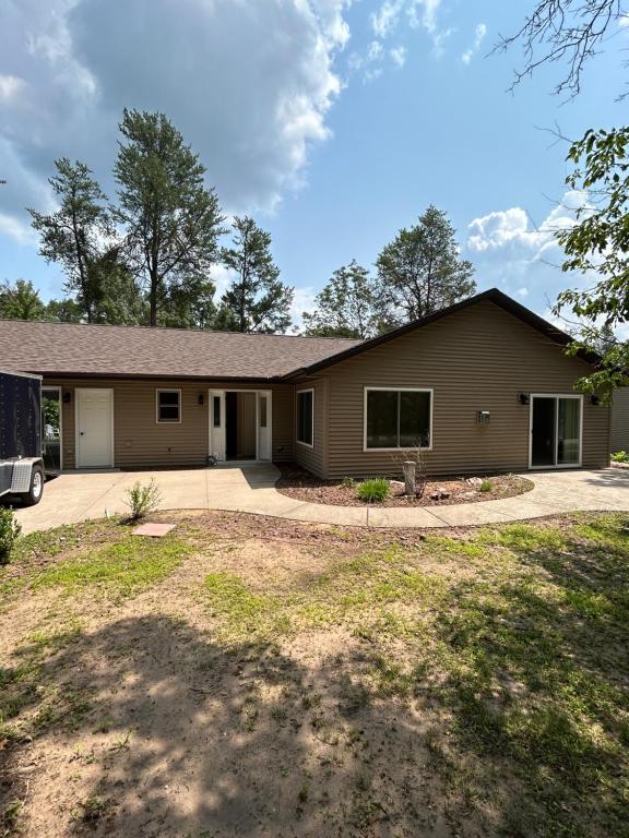 a house with a garage and a driveway at KSK Getaway in Nekoosa