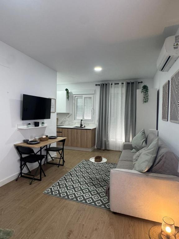 a living room with a couch and a table at Estudio Luminoso AM in Bollullos par del Condado