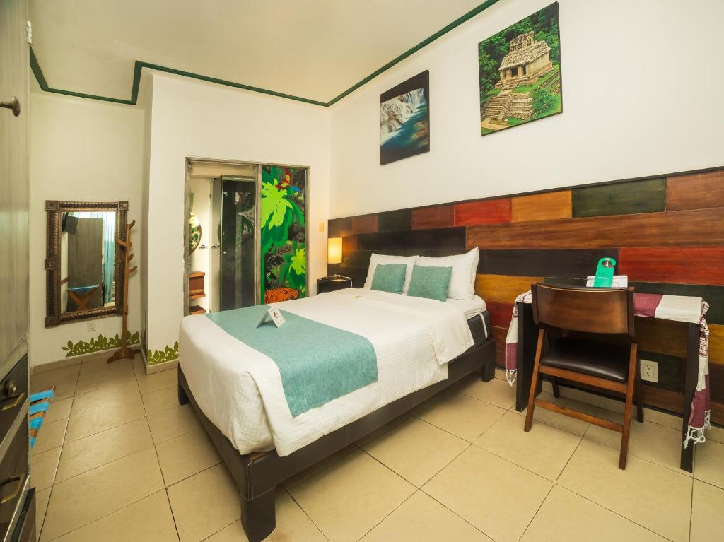 a bedroom with a bed and a desk and a desk at Hotel Casa Anzures in Mexico City