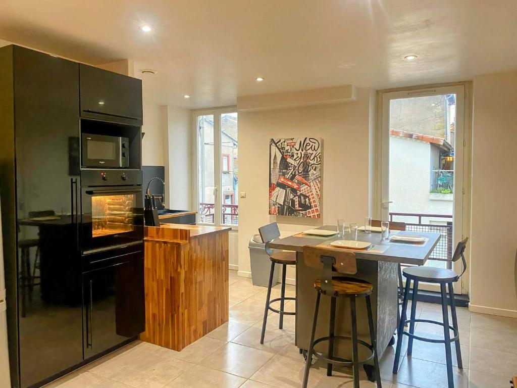 a kitchen with a island with a stove top oven at Le Calypso pour 4 pers CLIM CONFORT INTERNET PROCHE DE LA GARE in Marmande
