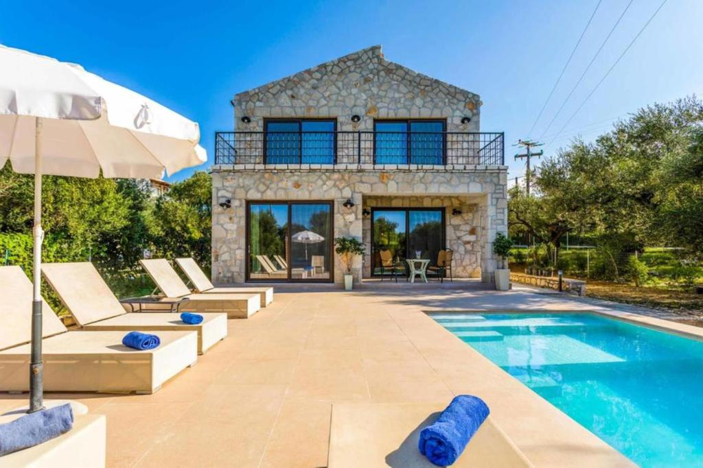 a villa with a swimming pool and a house at Neema Villa with Private Pool in Zakynthos