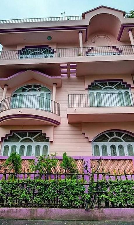 a pink building with windows and a balcony at ADRIJA Ck 140 Saltlake SEC-ll in kolkata