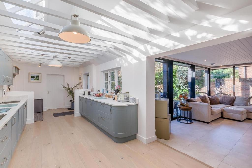 a kitchen and living room with a white ceiling at 5 Bed in Bosham oc-h33962 in Bosham