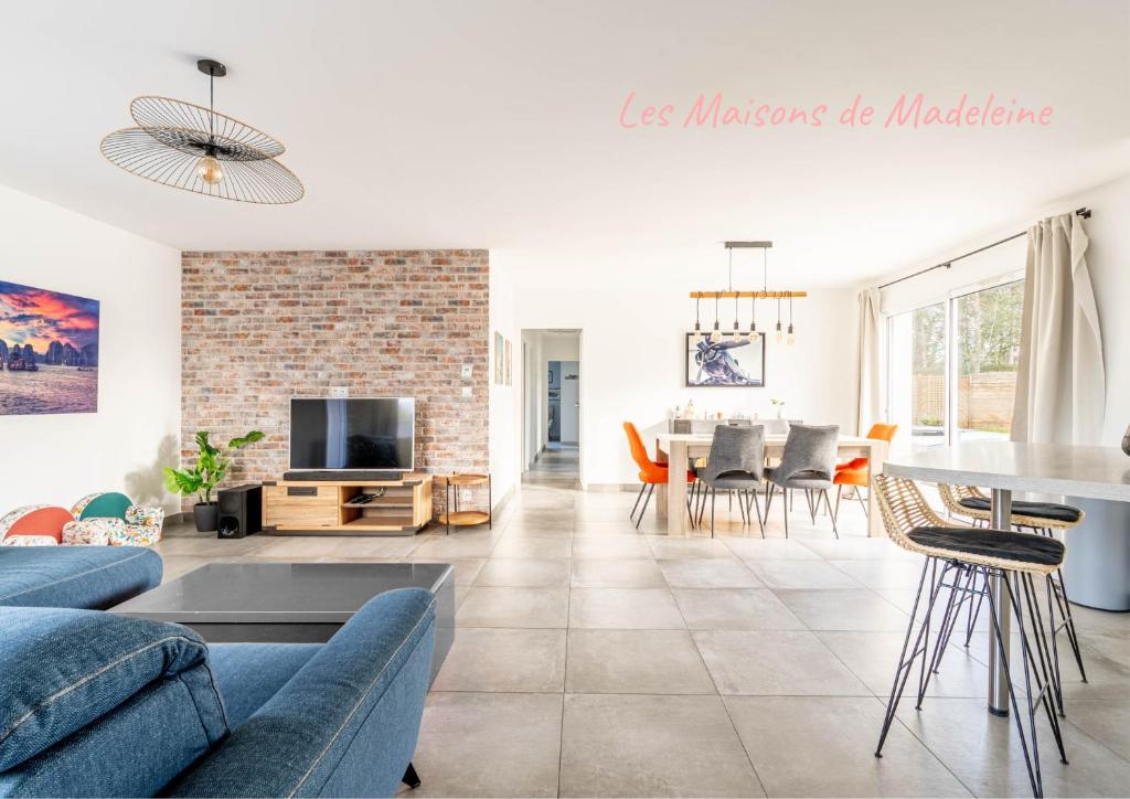 a living room with a couch and a table at Nouveau ! Bulle d'air - Maison avec piscine in Bouaye