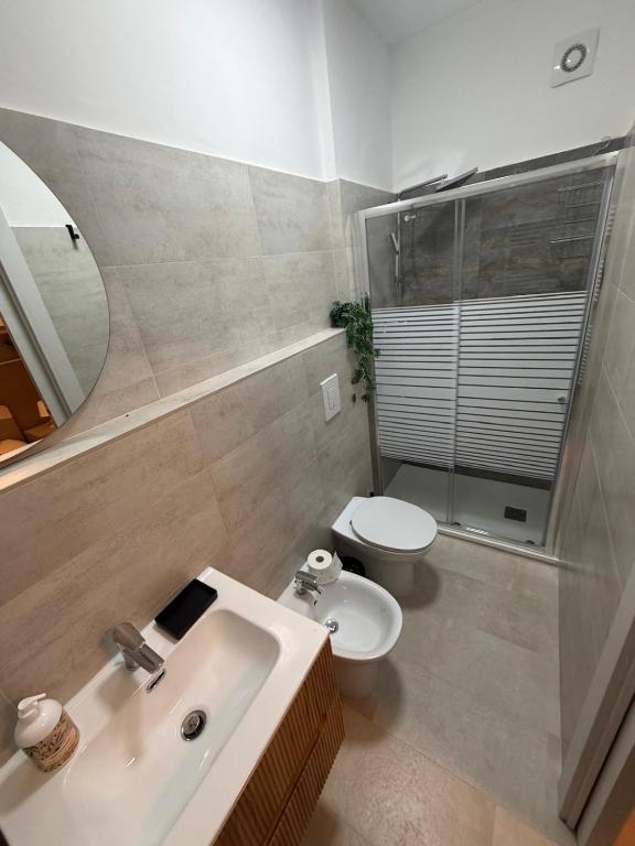 a bathroom with a sink and a toilet and a mirror at Il Covo dell'aquila in LʼAquila