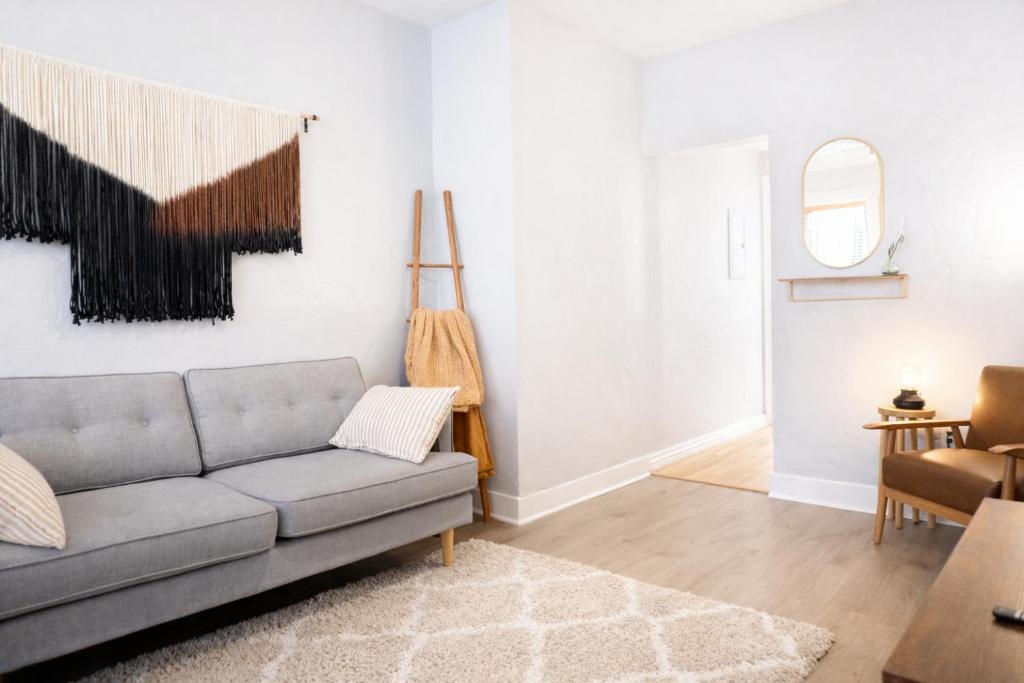 a living room with a couch and a mirror at Downtown Gem • King Bed • Fast WIFI in Salt Lake City