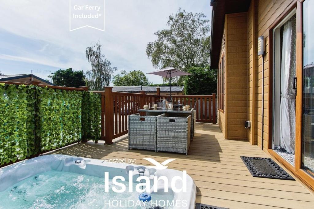 a deck with a hot tub on a house at The Lodge in Ryde