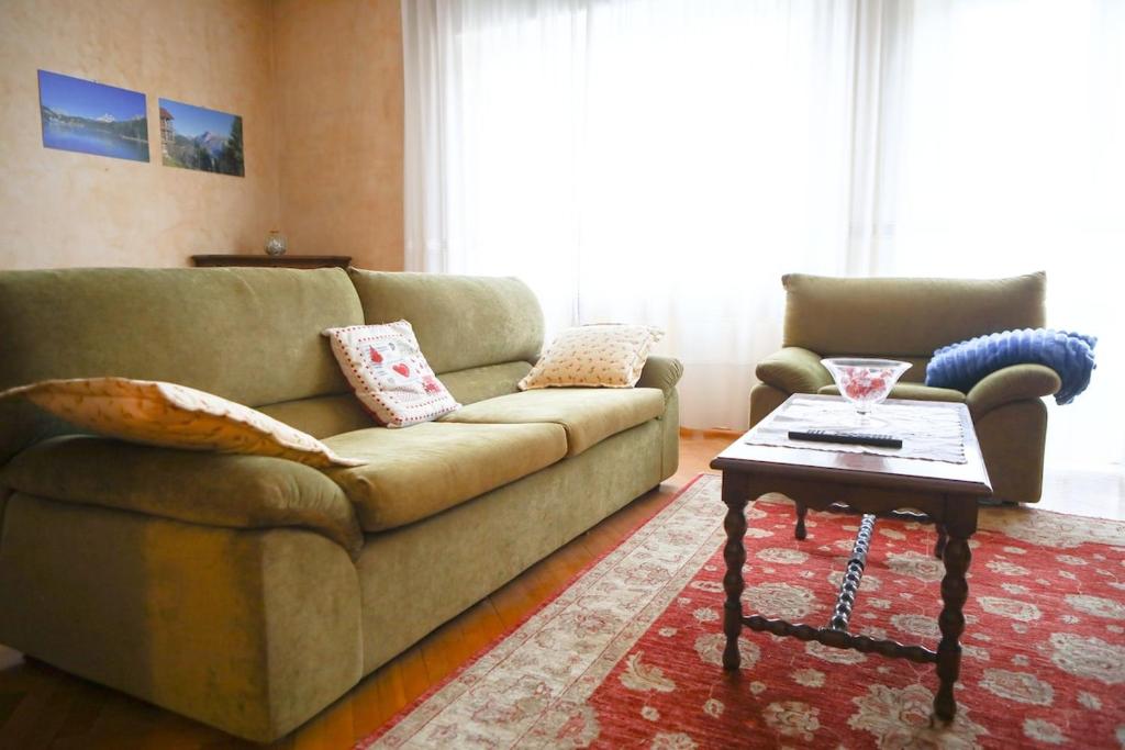 a living room with a couch and a coffee table at Casa Gabry - your first step in the Dolomites in Belluno