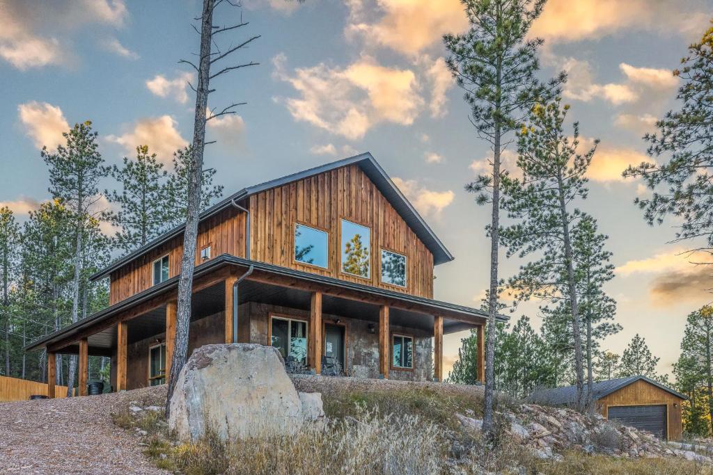 a house on top of a hill with trees at Pineview Cabin Retreat in the Black Hills- 4 bed, 2 bath in Sturgis