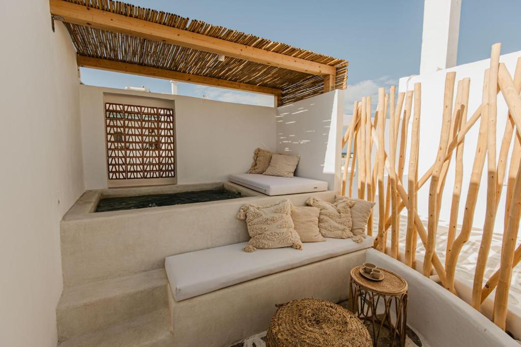 a balcony with a bench and a window at Maria's place boutique hotel in Antiparos